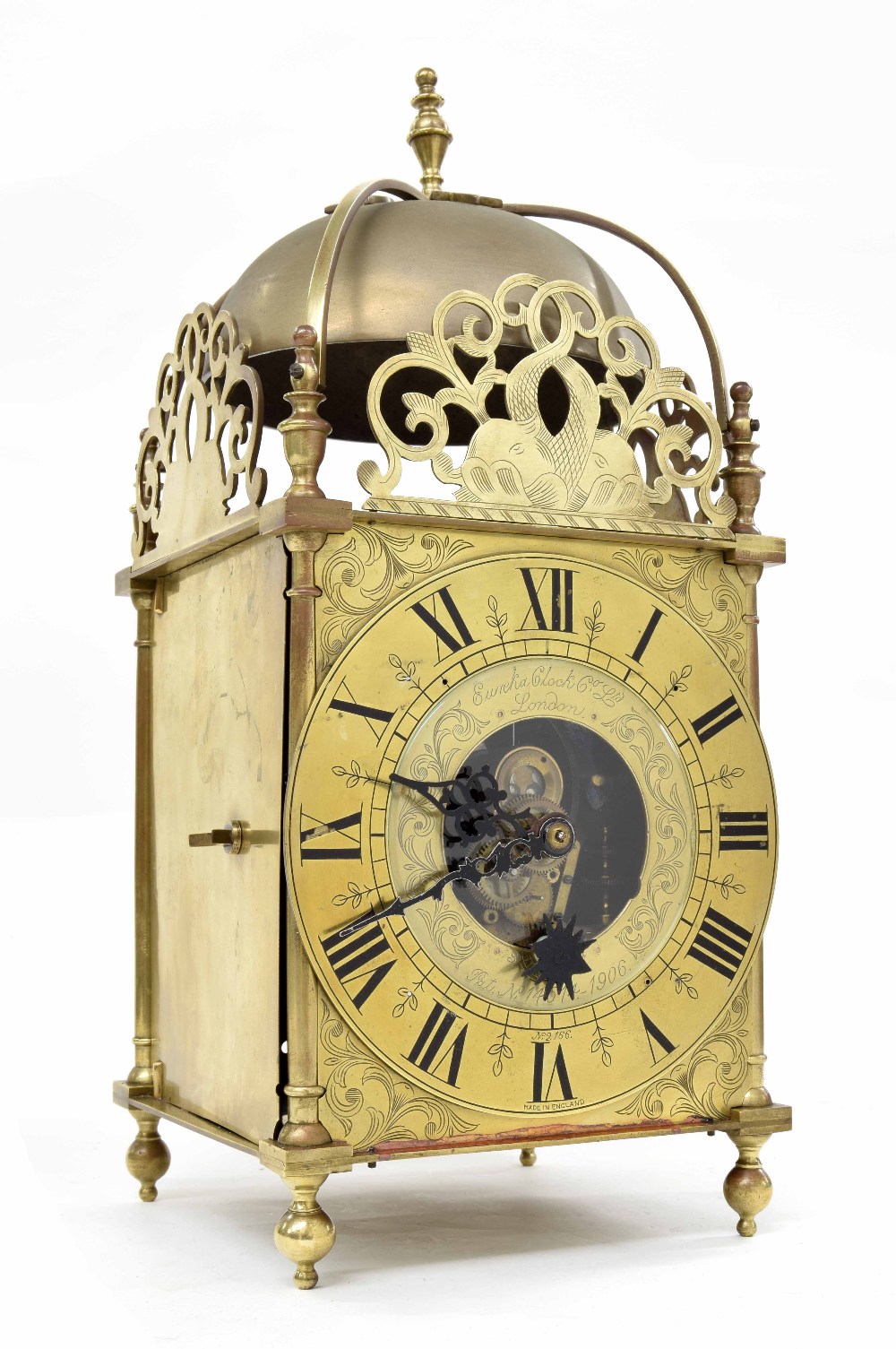 Good Cromwellian Eureka electric lantern clock, the 6.75" brass chapter ring enclosing a glazed