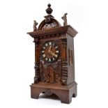 Good Black Forest trumpeter two train mantel clock, the 5.5" dial over the trumpeter door and within