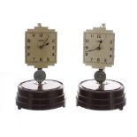 Two Tempex Art Deco electric clocks on Bakelite bases, under domes, with chrome posts and pendulums,