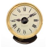 An unusual Bulle Clock in 11.5" diameter brass wall case, the painted skeletonised dial with exposed