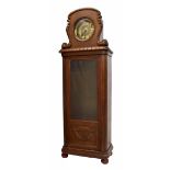 Unusual oak eight day longcase clock, the 9" round brass dial within a foliate carved surround