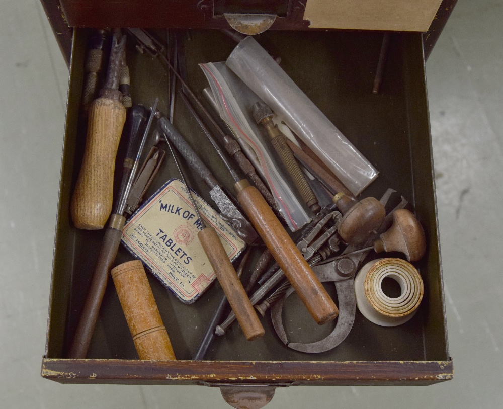 Clockmaker's metal upright chest of fifteen short drawers with contents including: clock parts, - Image 3 of 7