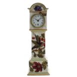 Attractive miniature pottery longcase clock, decorated overall in low relief with a bird amidst