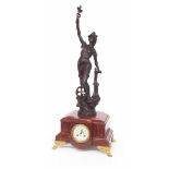 French red marble two train figural mantel clock striking on a bell, the 3" cream dial inset into