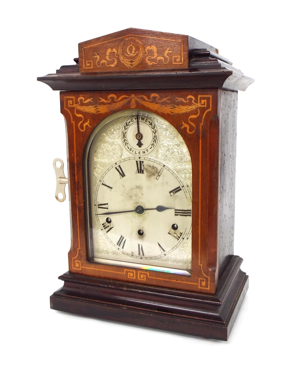 Mahogany inlaid three train mantel clock, the Kienzle movement striking on five gongs, the