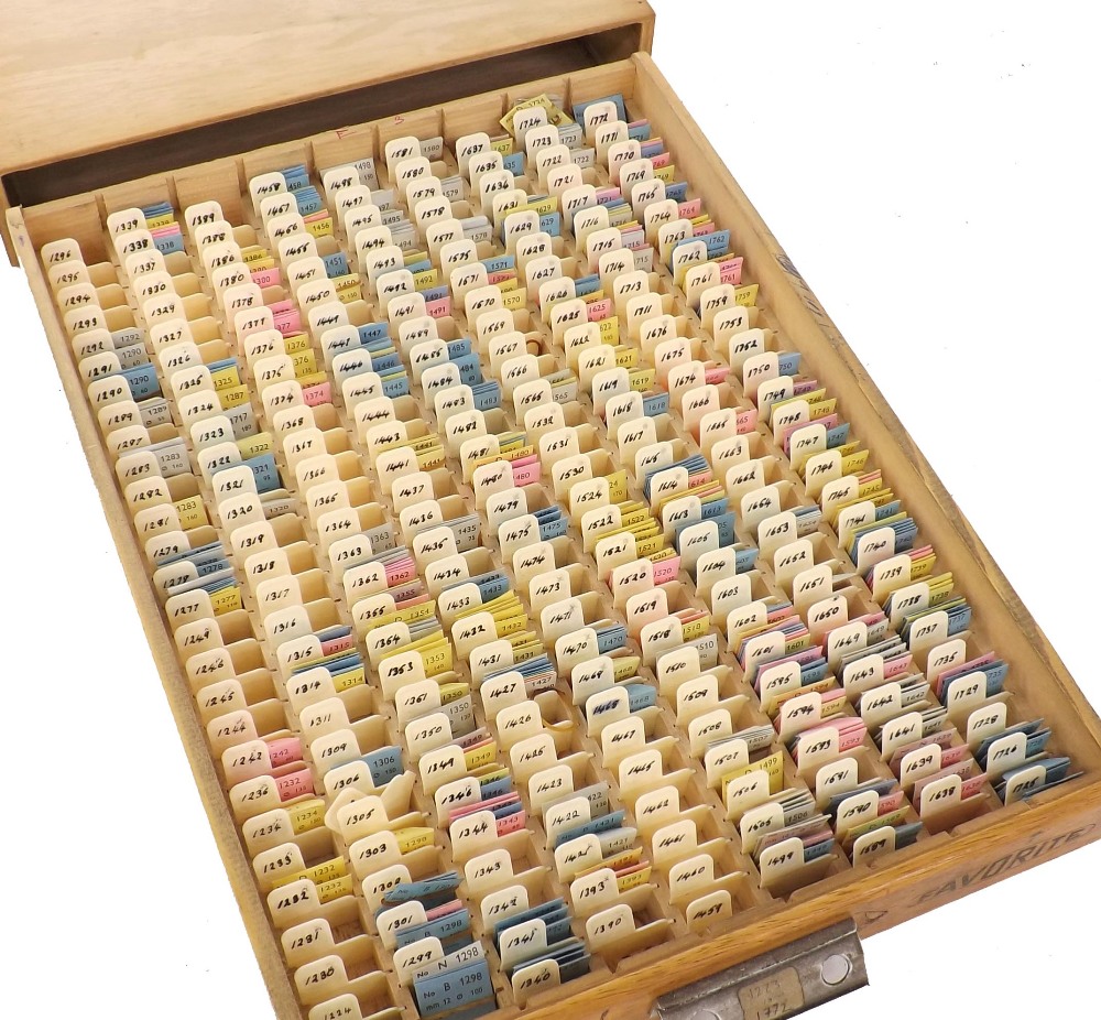 Favorite wooden drawer containing a large quantity of Favorite watch hands including nos. from