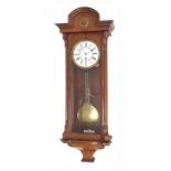 Walnut single train Vienna regulator wall clock, the 6.25" white dial within a glazed case, 37" high