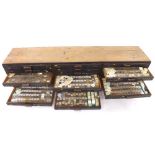 Twenty-one drawer wooden chest containing a very large quantity of watch stems (some with crowns)