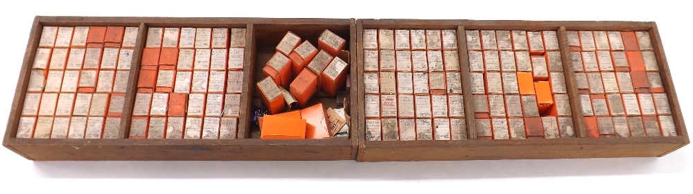 Two wooden trays containing a quantity of watch mainsprings