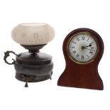 Two unusual late 19th/early 20th century backlit clocks, the first in the style of oil lamp with