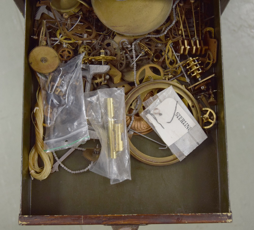 Clockmaker's metal upright chest of fifteen short drawers with contents including: clock parts, - Image 5 of 7