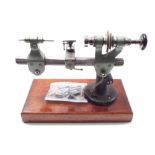 Pultra watchmaker's lathe, upon a mahogany plinth, 11.75" wide overall (with eight collets)