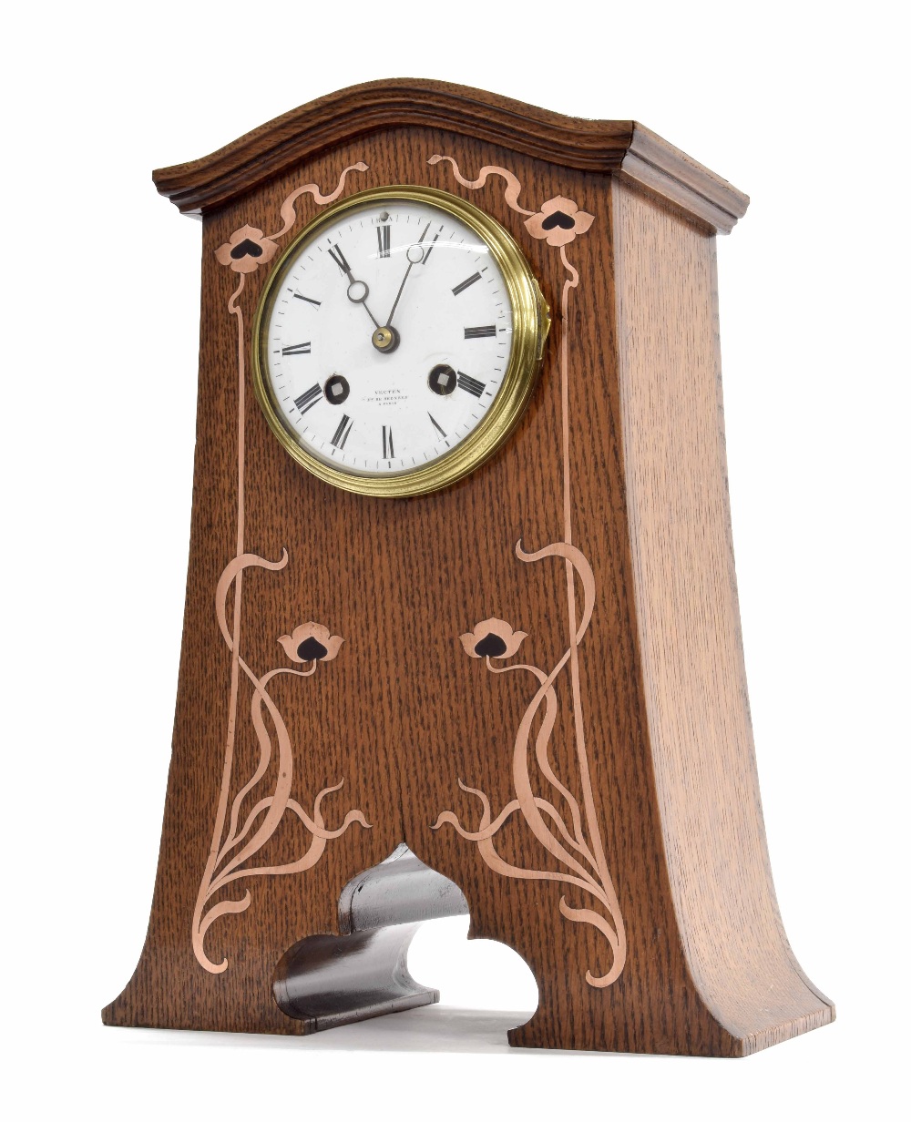 French oak Art Nouveau two train mantel clock striking on a gong, the 3.5" white dial signed