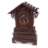 Black Forest two train cuckoo clock, the 5.5" dial within a carved chalet stepped case (in need of