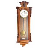 Walnut double weight Vienna regulator wall clock, the 7" white chapter ring enclosing a recessed