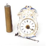 Miniature Black Forest timepiece, with white enamel dial and within a porcelain foliate moulded