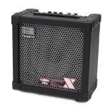 Roland Cube 30X guitar amplifier; together with a pair of Torque PA speakers