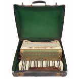 Soberano piano accordion, case; together with a Gisborne Class A ebonite piccolo within an old brown