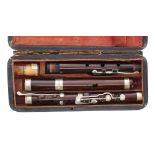 Old flute with eight nickel plated salt spoon keys on wooden blocks, cased