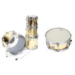 Remo Quadra four piece drum kit, made in USA, metallic gold finish, comprising 22" kick drum, 16"