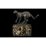 A Bronze Figure In The Form Of A Prowling Panther Raised on rectangular black marble base,