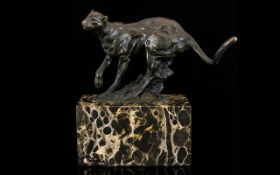 A Bronze Figure In The Form Of A Prowling Panther Raised on rectangular black marble base,