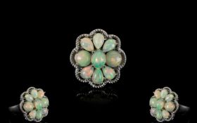 Opal Cluster Ring, comprising six pear cut and two round cut opal cabochons,