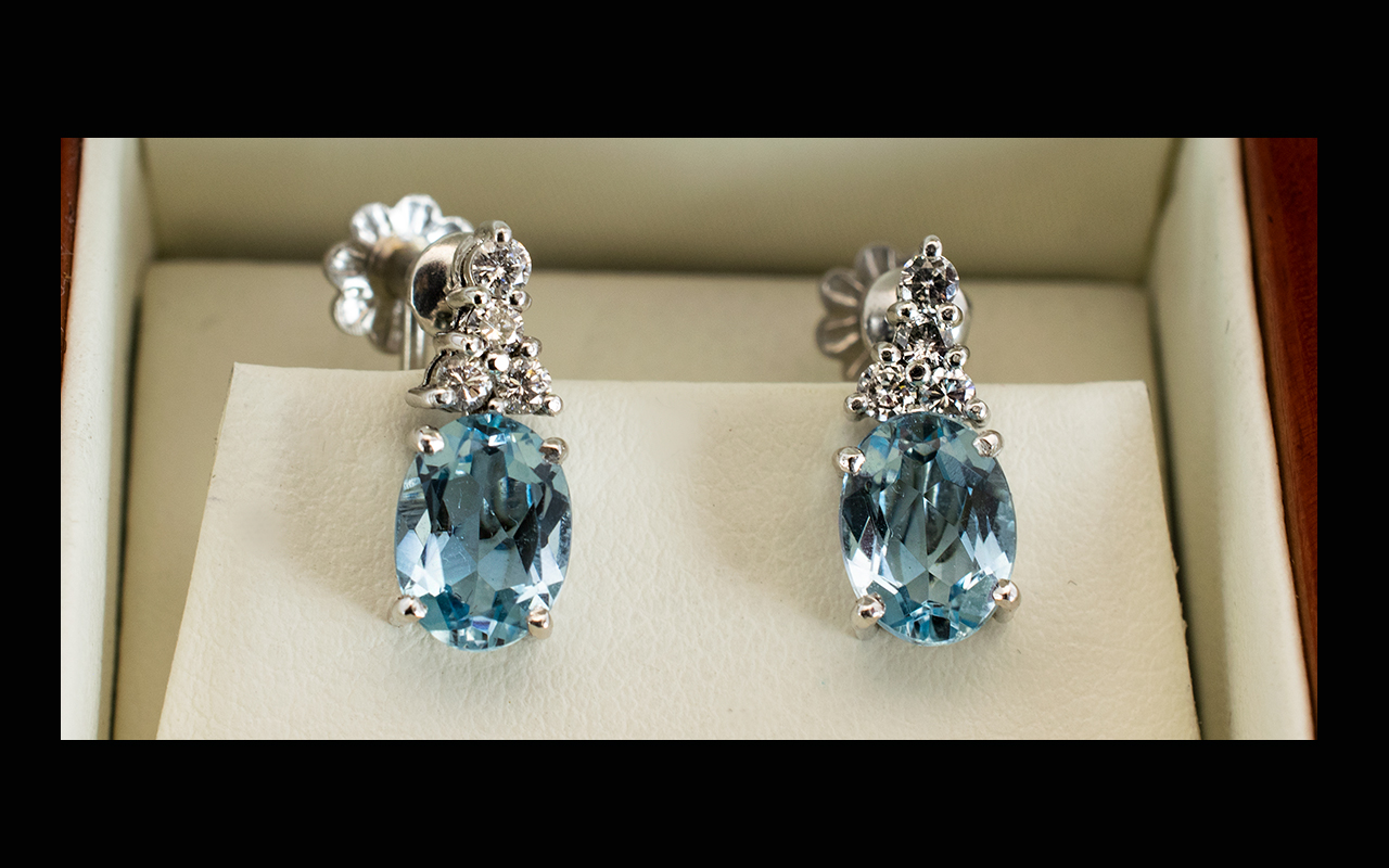 18ct White Gold Aquamarine And Diamond Drop Earrings The central oval cut stones of beautiful clear