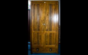 A Modern Dark Wood Wardrobe Comprising panelled doors,