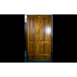 A Modern Dark Wood Wardrobe Comprising panelled doors,