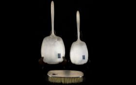 A Three Piece Silver Dressing Table Set To include hand mirror, hair brush and clothes brush.