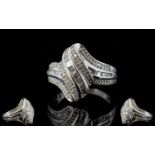 Diamond 'Wave' Ring, a row of baguette cut diamonds set between two rows of round cuts, totalling .