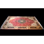 A Very Large Woven Silk Carpet Keshan rug with red ground and traditional Middle Eastern floral and