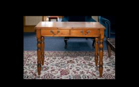 A Pine Side Table Comprising two frieze drawers and turned supports.