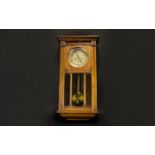 A 1930's Wall Mounted Clock In rectangular glazed case, Of typical form with brass dial. 28 inches