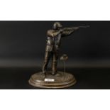 A Resin Figure In The Form Of A Clay Pigeon Shooter Bronzed resin figure,