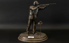 A Resin Figure In The Form Of A Clay Pigeon Shooter Bronzed resin figure,