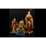 A Pair of Mid 20th Century Japanese Deity Doll Figures Each on wood stands,