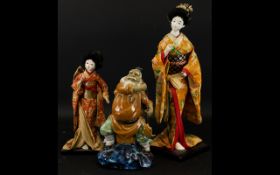 A Pair of Mid 20th Century Japanese Deity Doll Figures Each on wood stands,