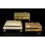 Three Brass Mounted Onyx Cigarette Boxes Each of rectangular form, each in good condition,