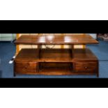 A Stained Beechwood Television Stand Two tier low table with two drawers and four apertures.