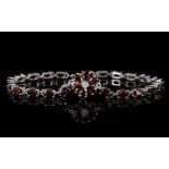 Red Garnet Line and Flower Bracelet, a floral shape comprising six pear cut red garnets,