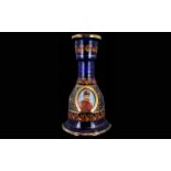 A Blue Glass Mallet Shaped Decanter With applied gilt decoration and portrait of Ottoman soldier to
