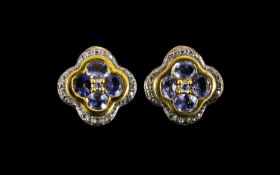 Tanzanite Pair of Quatrefoil Stud Earrings, the earrings having four round cut tanzanites of good