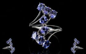 Tanzanite Crossover Ring, 3cts of oval cut tanzanites set in a 9ct white gold shank which divides