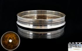 A Wonderful Silver And Polished Oak Large Table Coaster Comprising gallery top with pierced border