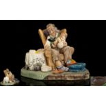 Stonecraft Handpainted Figure Group Titled 'Grandad's Darling' In the form of seated male figure