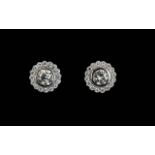 A Pair Of 18ct White Gold And Diamond Set Halo Earrings The central diamonds of approx 1.12 cts,