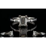 Platinum Emerald Cut Diamond Ring The central stone, set between two emerald cut diamond shoulders,