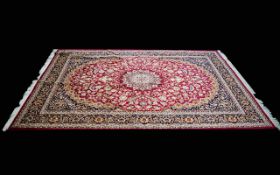 A Very Large Woven Silk Carpet Keshan rug with red ground and traditional Middle Eastern floral and